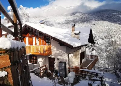 Villa Meledrio in Dimaro in winter, with snow-covered balconies and mountain views