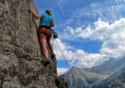 Rock climbing on a steep mountain wall with spectacular alpine views in Val di Sole, Dolomiti di Brenta