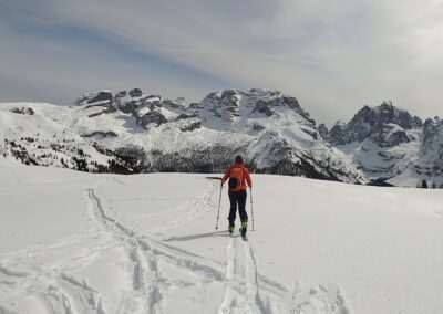 Ski touring through a snowy mountain landscape in the Brenta Dolomites